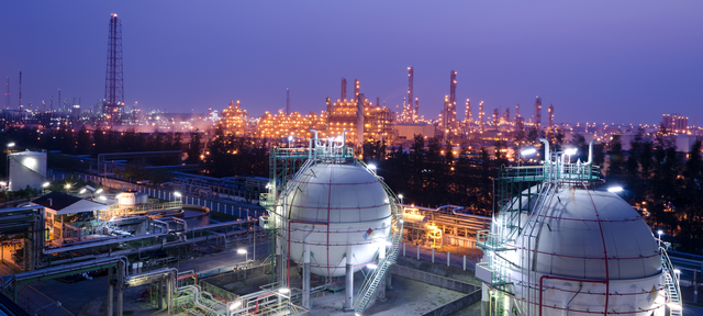 Gas storage spheres tank in petrochemical plant at night